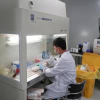 A scientist works at Zai Labo\'s drug development facility in Shanghai in October 2017. | REUTERS