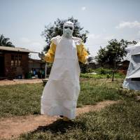 A health worker gets ready to perform medical checks inside an Ebola Treatment Center run by The Alliance for International Medical Action (ALIMA) in Beni, Congo, in August. The struggle to contain the latest Ebola outbreak in the Democratic Republic of Congo is facing a \"perfect storm\" of challenges, including rebel violence and pre-election manipulation, the U.N. said Tuesday. Attacks by armed opposition groups in North Kivu province hit by the outbreak have risen in recent weeks, including a deadly raid in the town of Beni that forced the World Health Organization to suspend its work, the agency\'s emergency response chief, Peter Salama, told reporters. | AFP-JIJI