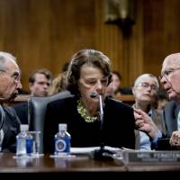 Senate Judiciary Committee Chairman Chuck Grassley, R-Iowa (left), accompanied by Sen. Dianne Feinstein, D-Calif., the ranking member, speaks with Sen. Patrick Leahy, D-Vt., during a Senate Judiciary Committee markup meeting on Capitol Hill Thursday in Washington. | AP