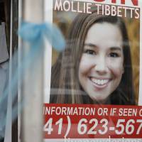 In this Aug. 21photo, a poster for missing University of Iowa student Mollie Tibbetts hangs in the window of a local business in Brooklyn, Iowa. Tibbetts was reported missing from her hometown in July and her body was found Aug. 21. Cristhian Bahena Rivera, the farmhand charged with her abduction and stabbing death, pleaded not guilty to first-degree murder Wednesday in Montezuma, Iowa. | AP