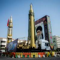 A display featuring missiles and a portrait of Iran\'s Supreme Leader Ayatollah Ali Khamenei is seen at Baharestan Square in Tehran last September. | TIMA / via REUTERS
