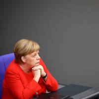 German Chancellor Angela Merkel is seen before the start of a session at the lower house of parliament in Berlin on Wednesday. | REUTERS