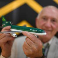 Michael Kelly holds a Lockheed Martin Tristar 500, an Aer Lingus model aircraft that is part of his collection, the world\'s largest, of diecast model aircraft unveiled at Shannon airport in Shannon, Ireland, Tuesday. | REUTERS