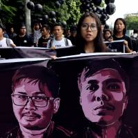 People march in a show of solidarity for jailed Reuters journalists Wa Lone and Kyaw Soe Oo in Yangon on Saturday. A Myanmar court sentenced the pair Monday to seven years in prison for illegal possession of official documents, a ruling that comes as international criticism mounts over the military\'s alleged human rights abuses against Rohingya Muslims. | REUTERS