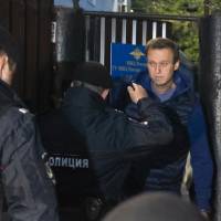 Police officers detain Russian opposition activist Alexei Navalny on Monday in Moscow as he leaves a detention center after a month in jail for an unsanctioned protest rally. | AP