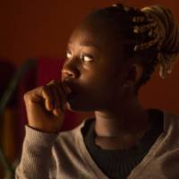 Trafficking victim Florence poses in her hair salon in Benin City, Nigeria, on June 30. | THOMSON REUTERS FOUNDATION/KAGHO IDHEBOR