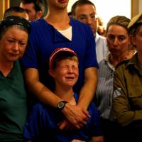 Relatives and friends mourn during the funeral of Ari Fuld, 45, an American-born Jewish settler fatally stabbed by a Palestinian, at a cemetery in Kfar Etzion in the occupied West Bank Sunday. | REUTERS