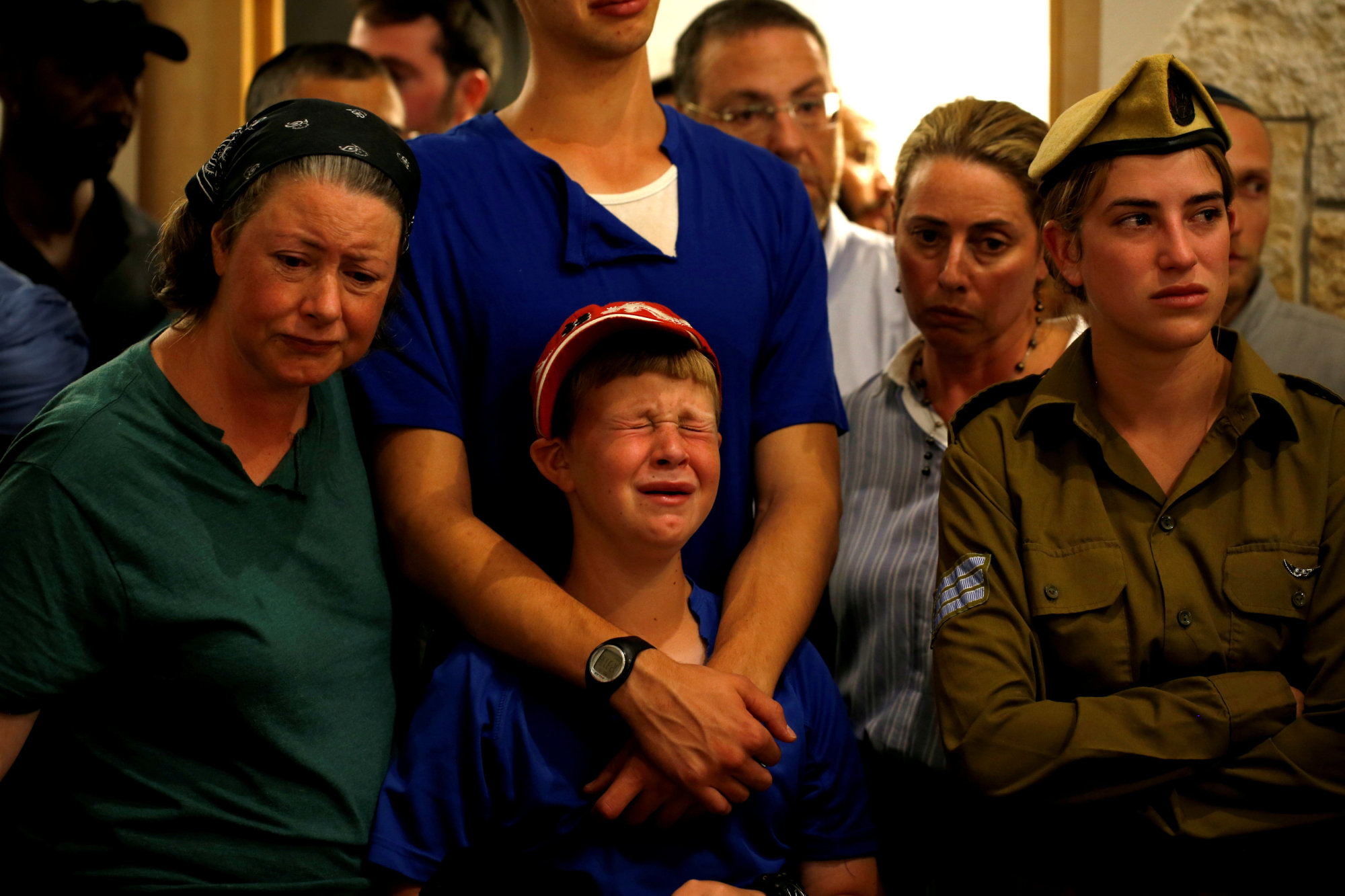Relatives and friends mourn during the funeral of Ari Fuld, 45, an American-born Jewish settler fatally stabbed by a Palestinian, at a cemetery in Kfar Etzion in the occupied West Bank Sunday. | REUTERS