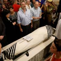 Relatives and friends mourn during the funeral of Ari Fuld, 45, an American-born Jewish settler fatally stabbed by a Palestinian, at a cemetery in Kfar Etzion in the occupied West Bank Monday. | REUTERS