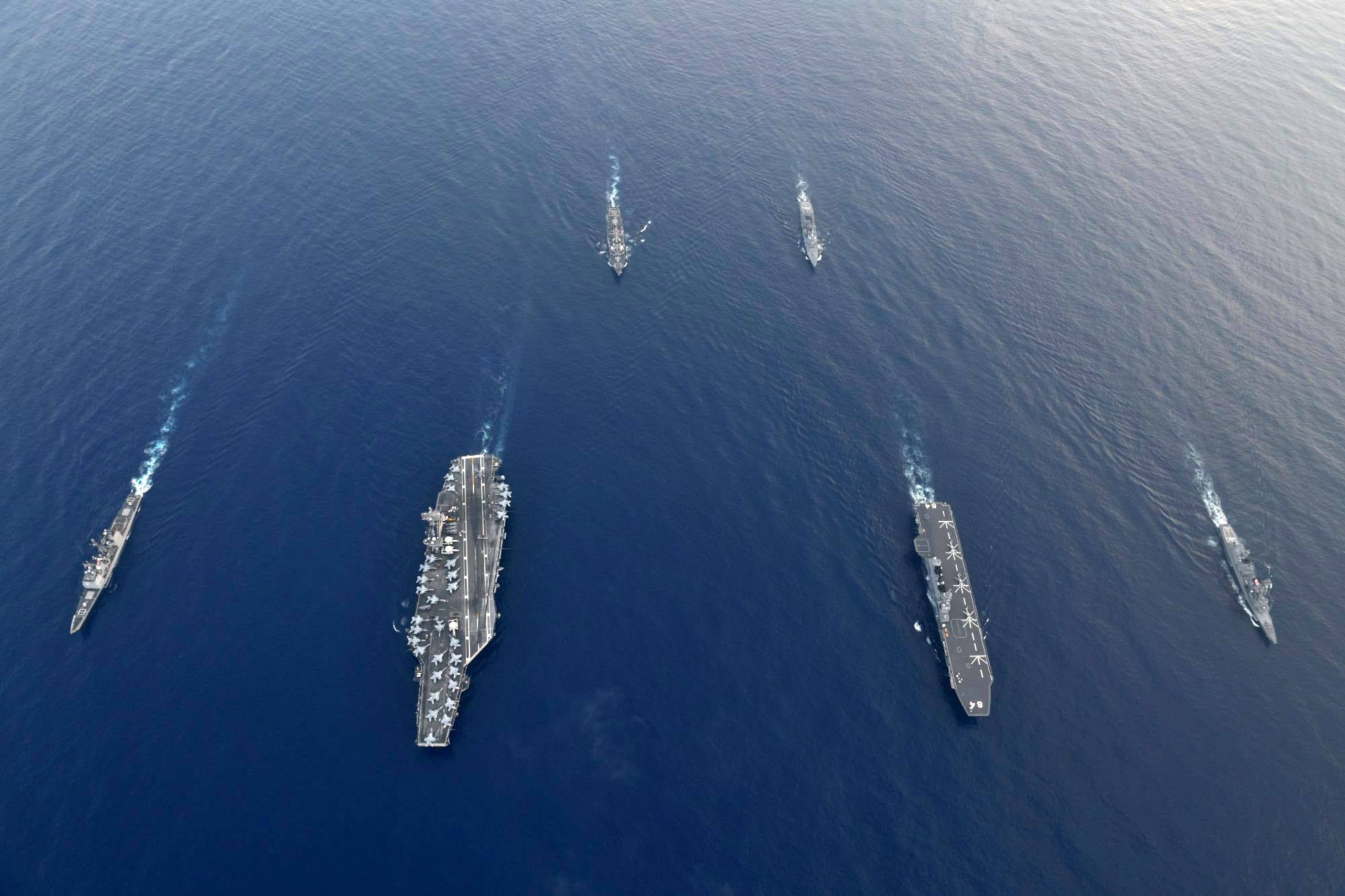 The U.S. Navy's USS Antietam guided-missile destroyer (from left), USS Ronald Reagan aircraft carrier, the USS Milius guided-missile destroyer and the Maritime Self-Defense Force's destroyer Suzutsuki, Kaga helicopter carrier and the Inazuma destroyer participate in bilateral training in the South China Sea on Friday. | MSDF