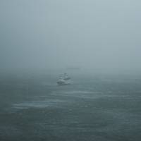 Waves break around a ship off Hong Kong during Typhoon Hato in August last year. | BLOOMBERG