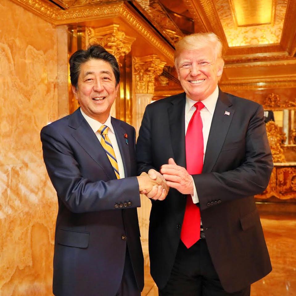 Shinzo Abe poses with U.S. President Donald Trump in this photo posted to the prime minister's official Facebook account Sunday. Abe met Trump for dinner and said they had a constructive talk. | REUTERS
