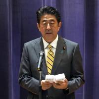 Prime Minister Shinzo Abe delivers a speech during the Self-Defense Forces senior officers\' gathering at Defense Ministry in Tokyo on Monday. Abe is planning to ask Chinese President Xi Jinping to ease Beijing\'s ban on importing some Japanese foods that followed the 2011 nuclear crisis. | AP