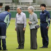 Emperor Akihito and Empress Michiko are seen after their arrival at a park in Kurashiki, Okayama Prefecture, on Friday. During their visit they met victims of July\'s deadly downpours in western Japan. | POOL / VIA KYODO