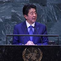 Prime Minister Shinzo Abe speaks at the U.N. General Assembly in New York on Tuesday. | AFP-JIJI