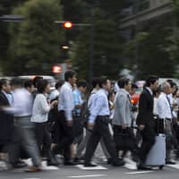 A Kyodo News survey showed that only 13 of 113 major firms polled are considering adopting the \"high-level professional system,\" a key pillar of Prime Minister Shinzo Abe\'s labor reforms, which will come into effect in April. | BLOOMBERG