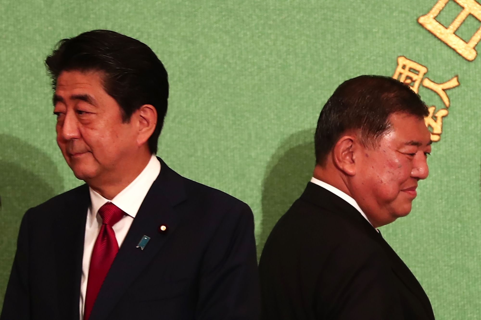 Prime Minister Shinzo Abe (left) and former Defense Minister Shigeru Ishiba attend a debate for the Liberal Democratic Party presidential election at the Japan National Press Club in Tokyo on Friday. | AFP-JIJI
