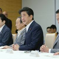 Prime Minister Shinzo Abe speaks during a Cabinet meeting on Thursday. The latest Kyodo News poll showed 61 percent of voters with membership in the ruling Liberal Democratic Party said they will vote for Abe in the Sept. 20 LDP presidential election. | AFP-JIJI