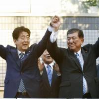 Prime Minister Shinzo Abe (left) and former Defense Minister Shigeru Ishiba ﷯pose after giving campaign speeches in the city of Saga on Saturday ahead of the Liberal Democratic Party\'s presidential election on Sept 20 . | KYODO