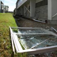 A window frame that fell from the gymnasium at Eniwaminami High School in the city of Eniwa, Hokkaido, during the Sept. 6 earthquake is seen Tuesday. | KYODO