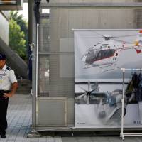 A Ground Self-Defense Force\'s recruiter stands in front of a promotional booth during a public relations event to attract recruits in Tachikawa, western Tokyo, on Aug. 26. | REUTERS