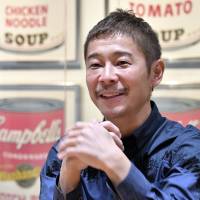 Japanese billionaire Yusaku Maezawa, founder of the nation\'s largest online fashion mall, speaks during an interview in Tokyo earlier this year with The Japan Times. | YOSHIAKI MIURA