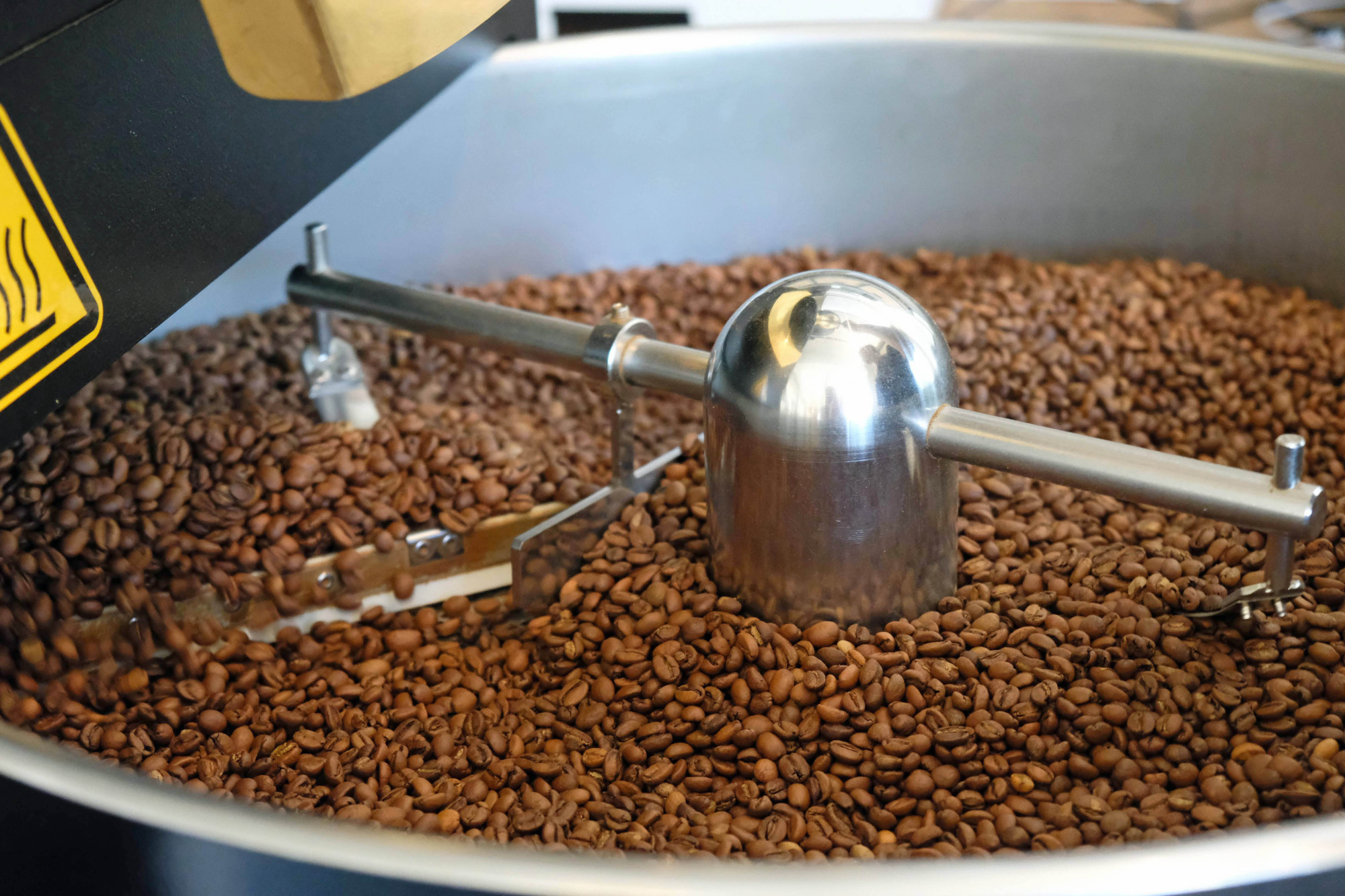 Post roast: Coffee beans are gently stirred and brought down to room temperature on a cooling sieve before storage. | CLAIRE WILLIAMSON