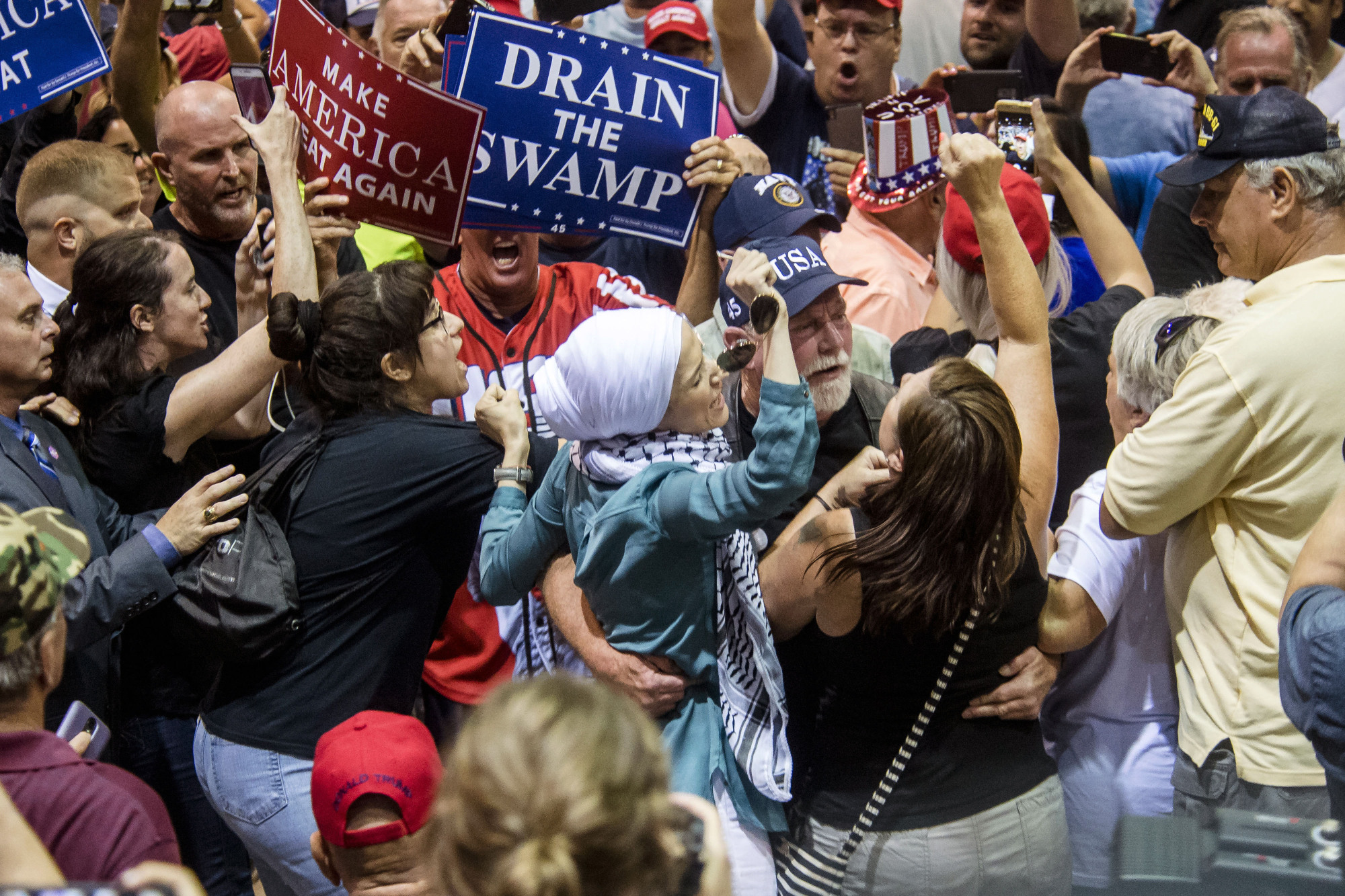 Supporters and protesters scuffle during a rally staged by U.S. President Donald Trump in Tampa, Florida, on July 31 | BLOOMBERG