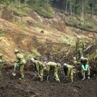 Self-Defense Forces personnel work at the site of a landslide in Atsuma, Hokkaido, on Sunday after a strong earthquake struck the country\'s northernmost island Thursday morning. | KYODO