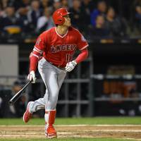 Los Angeles designated hitter Shohei Ohtani watches his three-run homer against Chicago leave the yard in the third inning on Friday night. | USA TODAY / VIA REUTERS