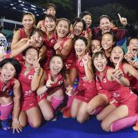 The Japan women\'s field hockey team celebrates its 2-1 upset victory over India in the gold-medal match at the Asian Games in Jakarta on Friday. | KYODO