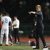 Cambodia general manager Keisuke Honda gives instructions during the friendly match between Cambodia and Malaysia in Phnom Penh on Monday. Malaysia won 3-1. | AP