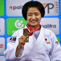 Tsukasa Yoshida poses with her gold medal during the medal ceremony for the under-57 kg women category of the 2018 Judo World Championships in Baku on Saturday. | AFP-JIJI
