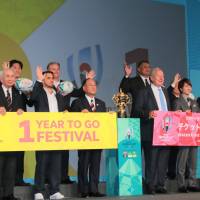 Rugby World Cup officials pose for photos at Meiji Kinenkan on Thursday. | KAZ NAGATSUKA