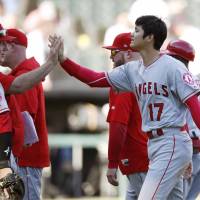 Shohei Ohtani celebrates with Angels manager Mike Scioscia following the team\'s 1-0 win over the White Sox on Sunday in Chicago | KYODO