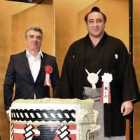 Georgian sumo wrestler Tochinoshin (right) poses with Georgian Ambassador Levan Tsintsadze during a ceremony to celebrate Tochinoshin\'s advancement to the rank of ozeki at Tokyo Dome Hotel on Sept. 1. | YOSHIAKI MIURA