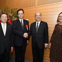 Uruguay Ambassador Cesar Ferrer (second from right) and his wife, Ana Maria, pose for a photo with Latin American and Caribbean Affairs Bureau Director-General Takahiro Nakamae (second from left) and Kazuto Ito, president of the Min-On Cocert Association, during a cocktail reception to celebrate Uruguay\'s independence day at the Min-On Cultural Center in Tokyo on Sept. 4. | YOSHIAKI MIURA