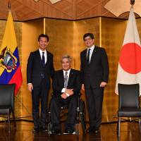 Ecuadorian President Lenin Moreno Garces (center) poses for a photo with Mitsunari Okamoto (left), parliamentary vice-minister for foreign affairs, and Jose Valencia, minister for foreign affairs and human mobility of Ecuador, during a reception to celebrate the 100th anniversary of the establishment of diplomatic relations between Ecuador and Japan at Hotel New Otani in Tokyo on Sept. 6. | YOSHIAKI MIURA