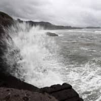 Waves hit the seawalls at a coast of Shibushi, Kagoshima Prefecture, on Saturday as Typhoon Trami approaches Kyushu. | AFP-JIJI