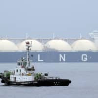 A Liberian LNG tanker arrives at a port in Yokohama in April 2014. Japan logged a current account surplus of ¥1.84 trillion in August,  marking the 50th straight month of black ink, government data showed Tuesday, though energy imports such as crude oil and liquid natural gas soared. | AP