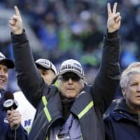 Seattle Seahawks owner Paul Allen holds his fingers up as a \"1\" and a \"2\" to symbolize the \"12th Man\" support of fans after the team beat the Green Bay Packers in the NFL football NFC Championship game in Seattle in 2015. The Billionaire Seahawks owner and Microsoft co-founder says cancer he was treated for in 2009 has returned. | AP
