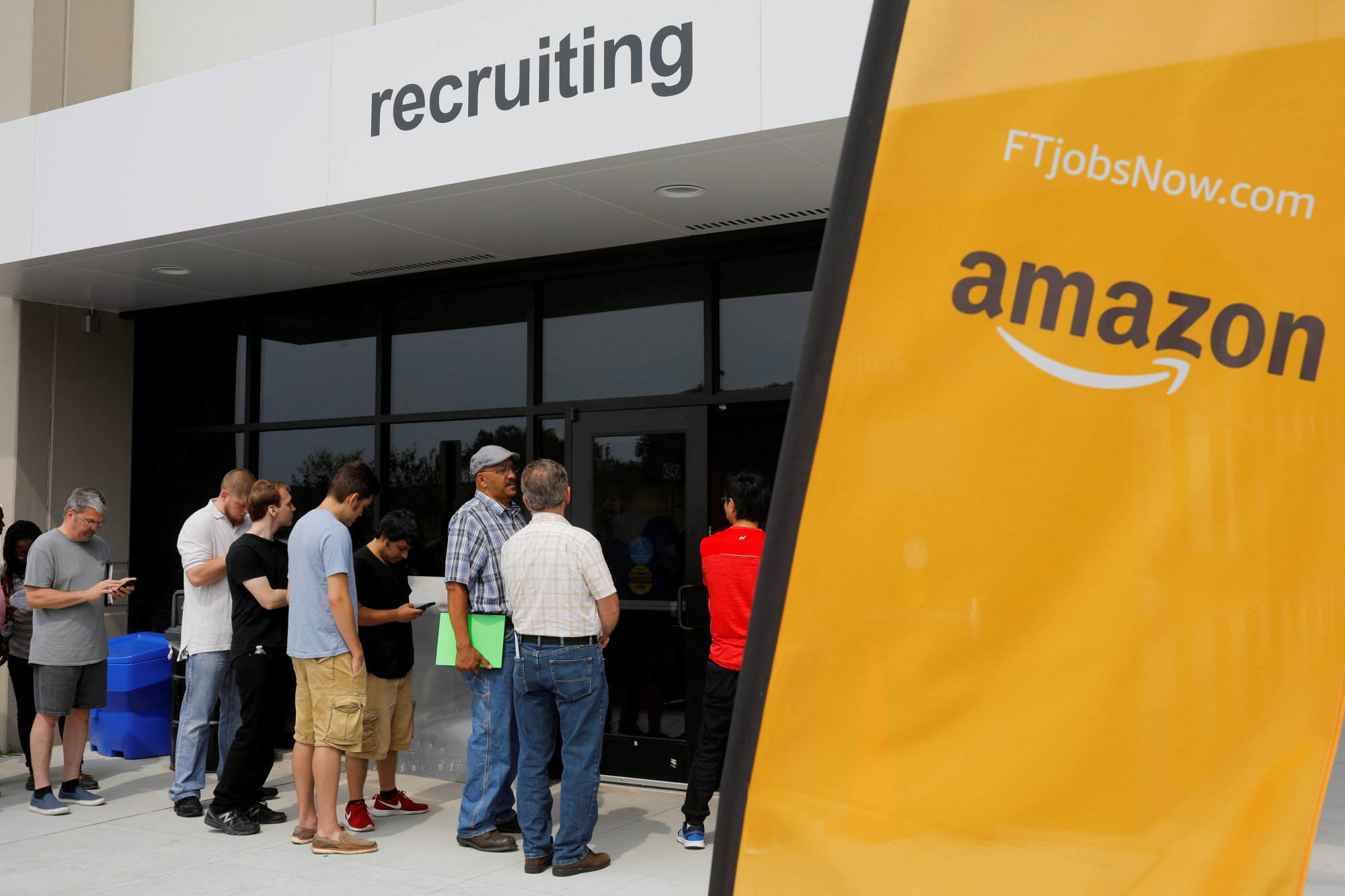 Job seekers line up to apply during 'Amazon Jobs Day,' a job fair at the Amazon.com Fulfillment Center in Fall River, Massachusetts, in 2017. | REUTERS