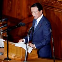 Finance Minister Taro Aso delivers his policy speech at the Diet on Wednesday. | REUTERS