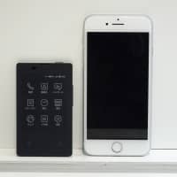 NTT Docomo Inc.’s new business-card-sized phone is seen next to Apple’s iPhone 8 on Wednesday. | KAZUAKI NAGATA