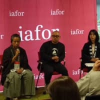 Masao Hosoo (left), president of Hosoo Corp., which has been crafting Nishijin-ori textiles for more than 300 years, speaks during the Global Innovation Value Summit in Tokyo on Friday. | KAZUAKI NAGATA