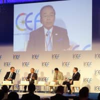 Toyota Motor Corp. Chairman Takeshi Uchiyamada (second from left) speaks during the fifth annual Innovation for Cool Earth Forum in Tokyo on Oct. 10. | KAZUAKI NAGATA