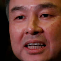 SoftBank Group Corp. CEO Masayoshi Son speaks to the press after meeting with then-U.S. President-elect Donald Trump in New York in December 2016. | REUTERS