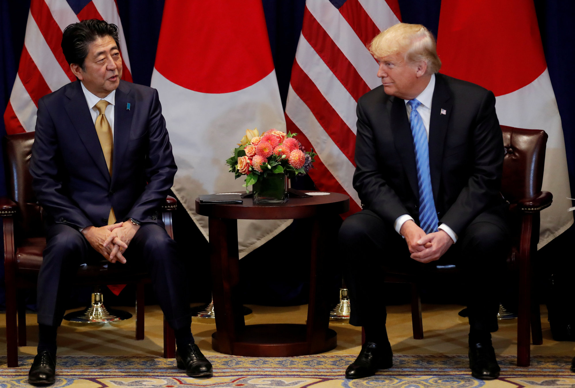 U.S. President Donald Trump listens to Prime Minister Shinzo Abe during a bilateral meeting at the United Nations on Sept. 26. | REUTERS