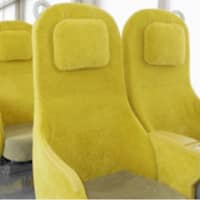 Seibu Railway\'s new Laview limited express train features soft yellow seats that resemble sofas. | SEIBU RAILWAY / VIA KYODO