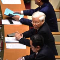 Vietnam\'s Nguyen Phu Trong (center) sits with with Prime Minister Nguyen Xuan Phuc (top) and president of Vietnam Fatherland Front, Tran Thanh Man, during the National Assembly\'s autumn session opening in Hanoi on Monday. Trong, the architect of an ongoing crackdown on corruption, was elected as the country\'s new president Tuesday. | AFP-JIJI